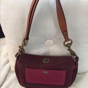 Coach plum with terra-cotta leather handle.